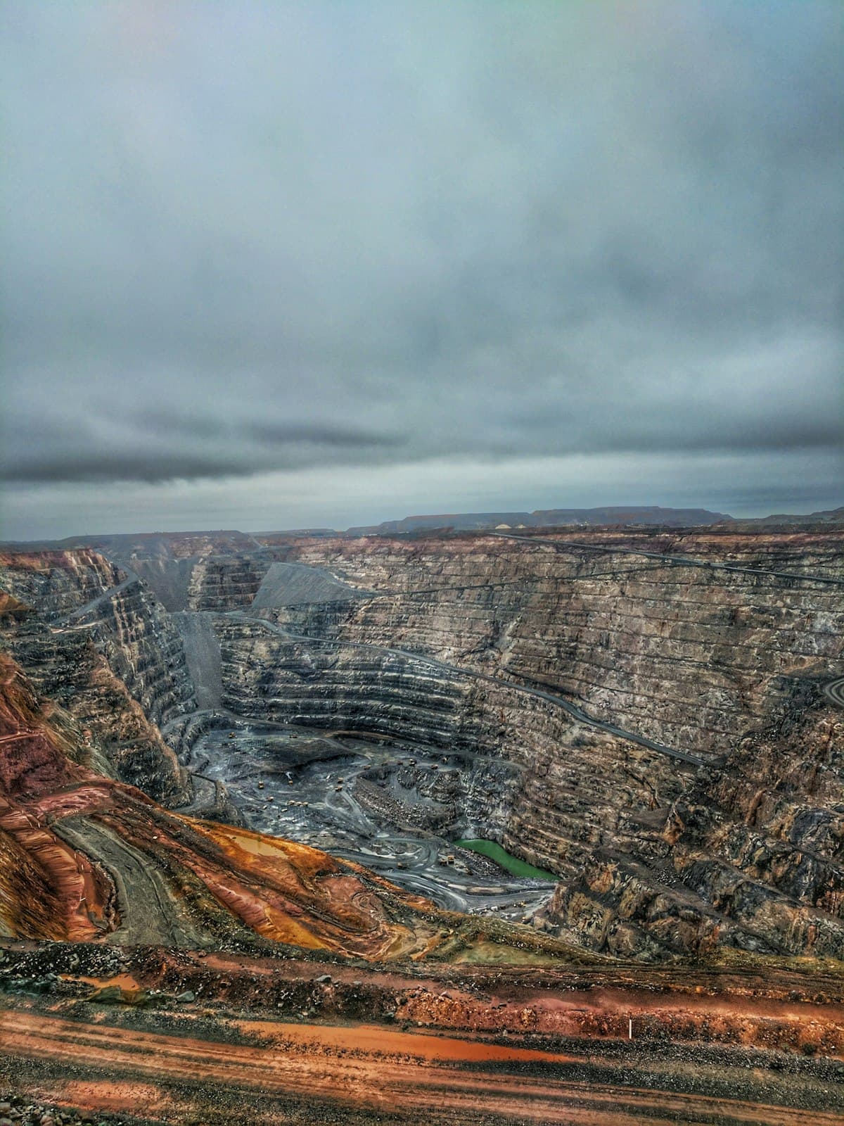 Aerial view of a large open pit mine where raw materials for electronics are extracted
